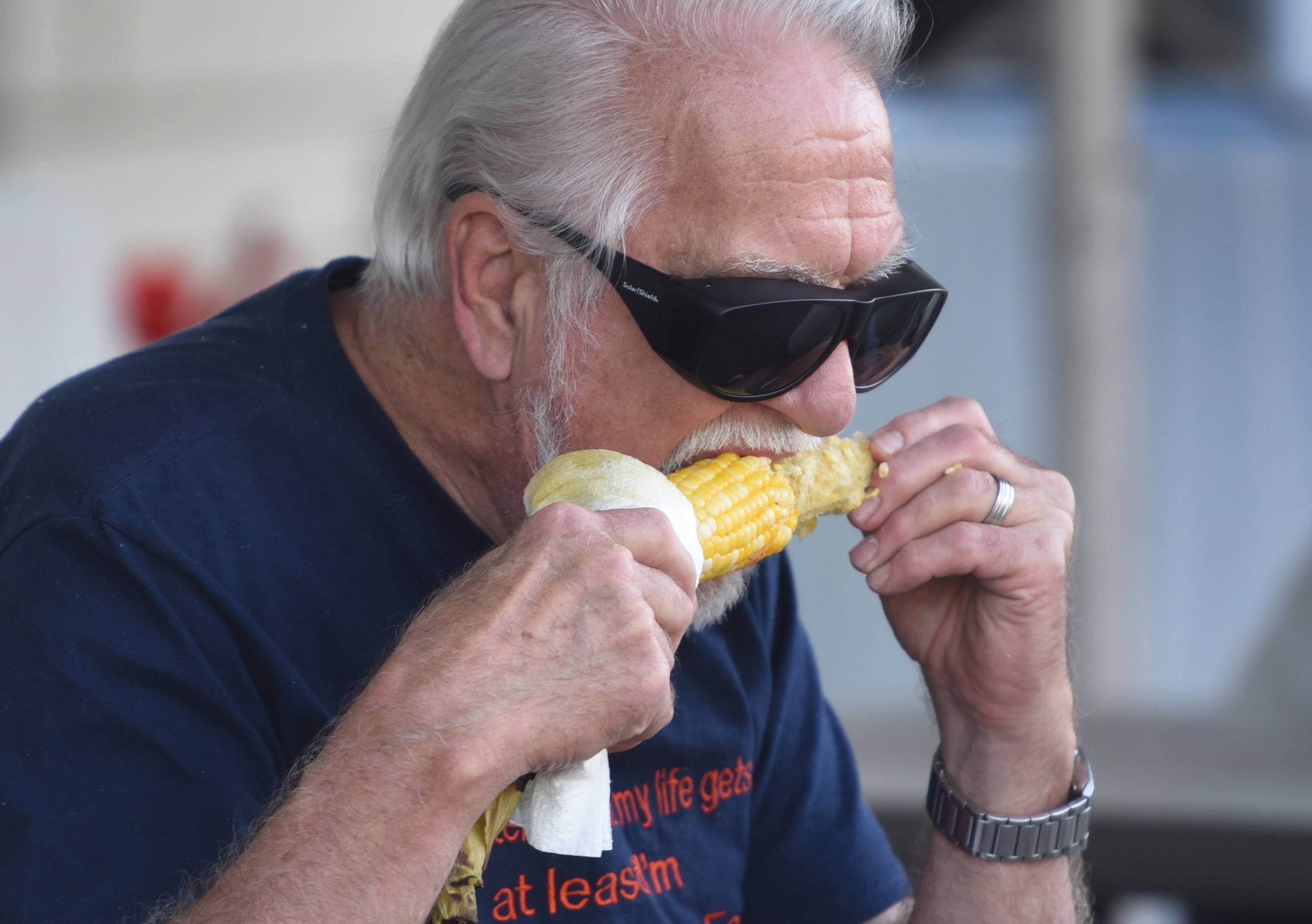 Des Plaines resident Gig Brzezinski tries out the corn Friday during the first dat of the Taste of Des Plaines festival in downtown Des Plaines.