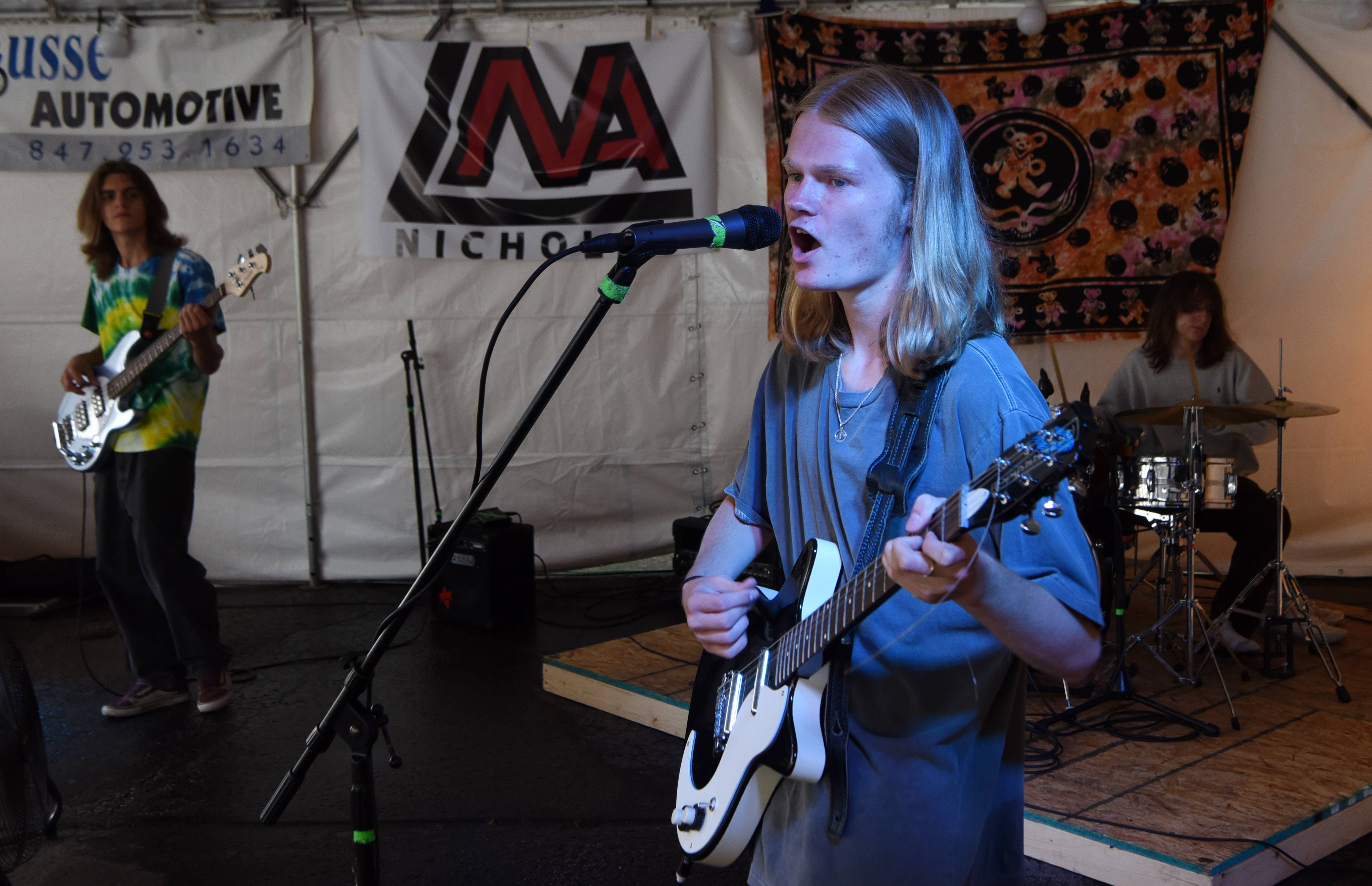 Reid Isbell of the band Red Orange sings and plays guitar alongside bassist Noah Christensen and drummer Ian Spenneer at Mrs. P and Me during the 56 Music Fix in downtown Mount Prospect Saturday.