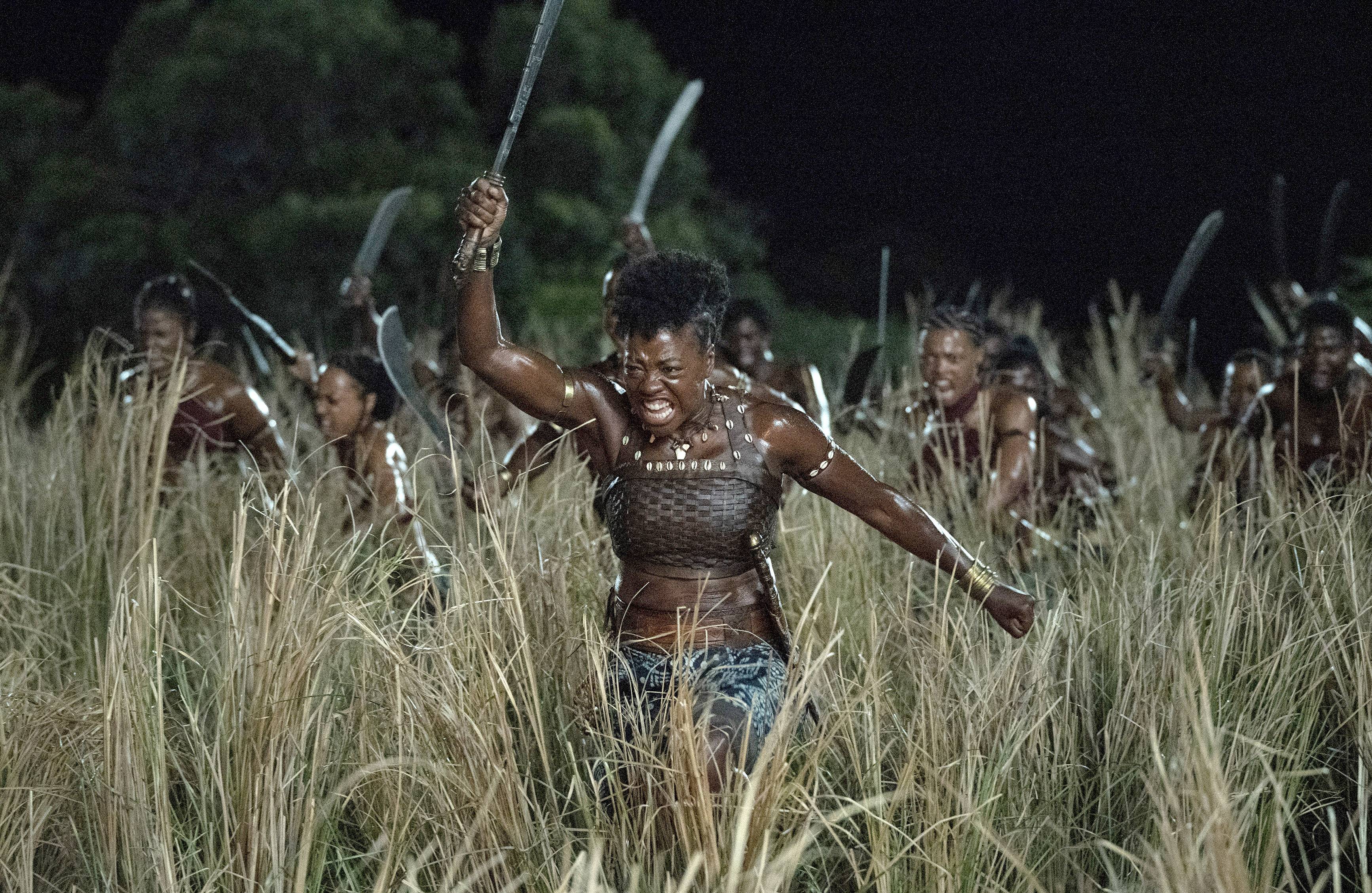 General Nanisca (Viola Davis) and the Agojie fighters storm into battle in "The Woman King."