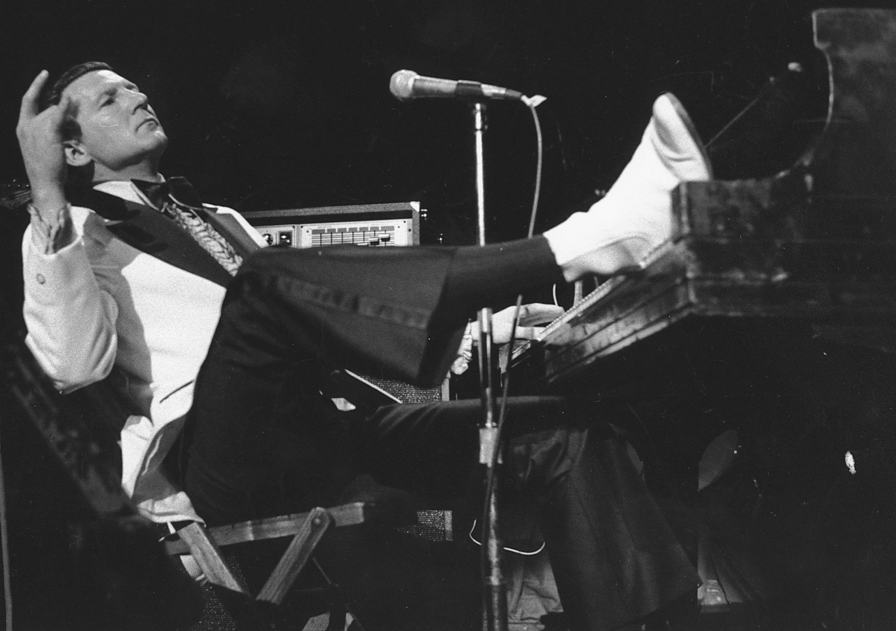 Jerry Lee Lewis props his foot on the piano as he lays back and acknowledges the applause of fans during the fifth annual Rock 'n' Roll Revival at New York's Madison Square Garden. Spokesperson Zach Furman said Lewis died Friday morning, Oct. 28, 2022, at his home in Memphis, Tenn. He was 87.