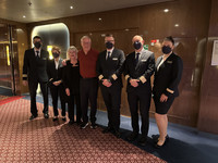  The author and her husband pose with some of the crew of Holland America's Nieuw Statendam. Photo courtesy of Sharon Whitley Larsen. 